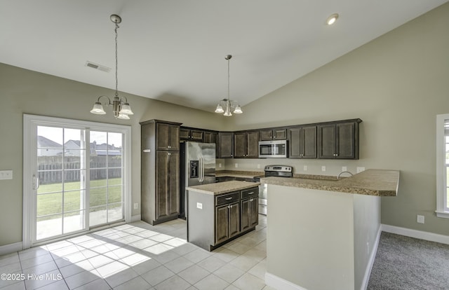 kitchen featuring dark brown cabinetry, appliances with stainless steel finishes, a chandelier, and visible vents