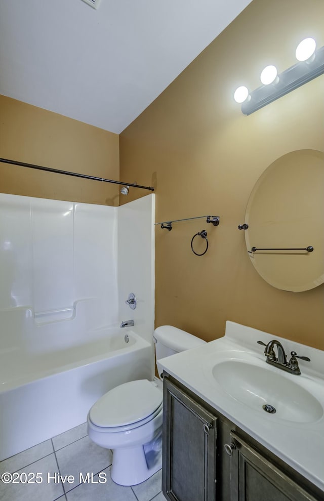 full bath with tile patterned floors, vanity, shower / washtub combination, and toilet