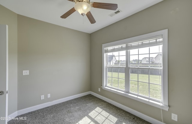 carpeted empty room with ceiling fan, baseboards, and visible vents