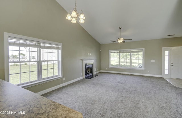 unfurnished living room featuring high vaulted ceiling, a tile fireplace, baseboards, carpet flooring, and visible vents