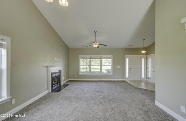 unfurnished living room with baseboards, carpet floors, a ceiling fan, and a fireplace