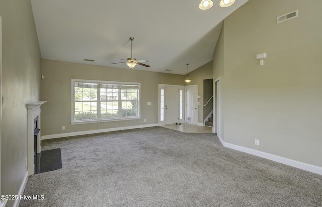 unfurnished living room featuring stairway, a ceiling fan, a fireplace with flush hearth, carpet floors, and baseboards