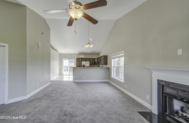 unfurnished living room featuring a fireplace with flush hearth, baseboards, high vaulted ceiling, ceiling fan, and carpet floors
