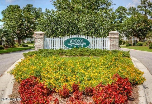 community / neighborhood sign with fence
