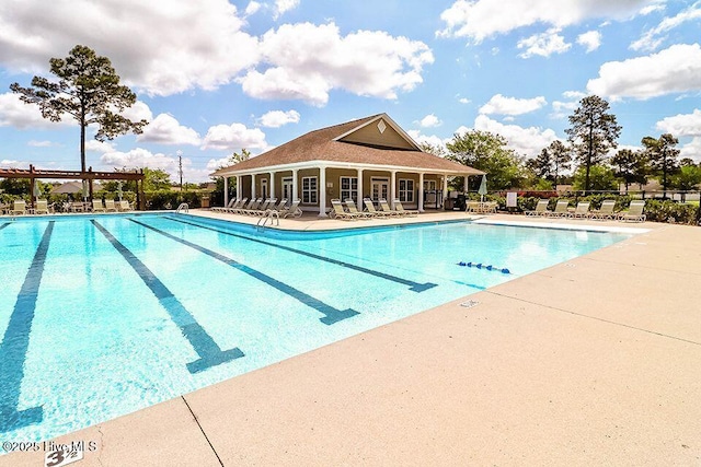 community pool with fence and a patio area