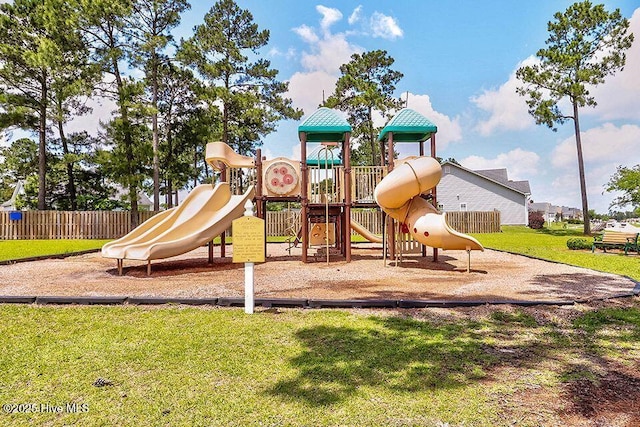 communal playground with a lawn and fence