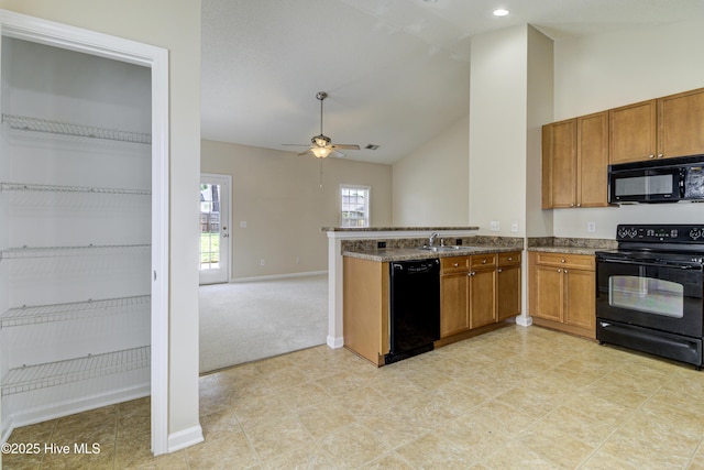 kitchen with black appliances, brown cabinets, a ceiling fan, and a sink