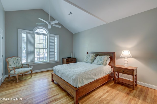 bedroom featuring a ceiling fan, baseboards, lofted ceiling, and light wood-type flooring