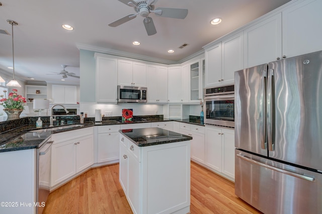 kitchen featuring appliances with stainless steel finishes, white cabinetry, a ceiling fan, and a sink