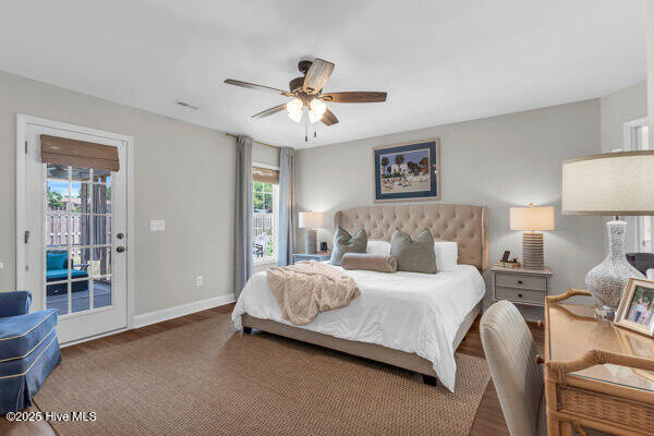bedroom with access to exterior, a ceiling fan, wood finished floors, and baseboards