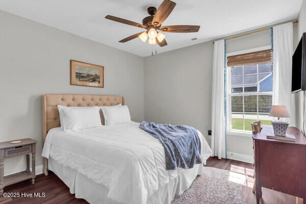 bedroom featuring a ceiling fan, wood finished floors, and baseboards