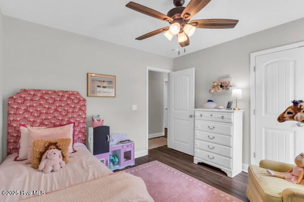 bedroom with wood finished floors, ceiling fan, and baseboards
