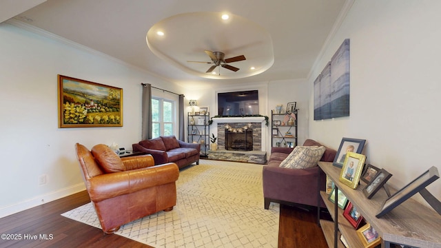 2417 Turtle Bay Dr, New Bern, NC 28562 - living room featuring crown molding, a fireplace, a ceiling fan, baseboards, and wood finished floors