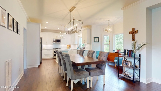 2417 Turtle Bay Dr, New Bern, NC 28562 - dining area featuring an inviting chandelier, baseboards, crown molding, and dark wood-style floors