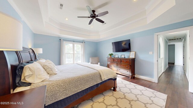 2417 Turtle Bay Dr, New Bern, NC 28562 - bedroom featuring crown molding, a raised ceiling, visible vents, and hardwood / wood-style flooring