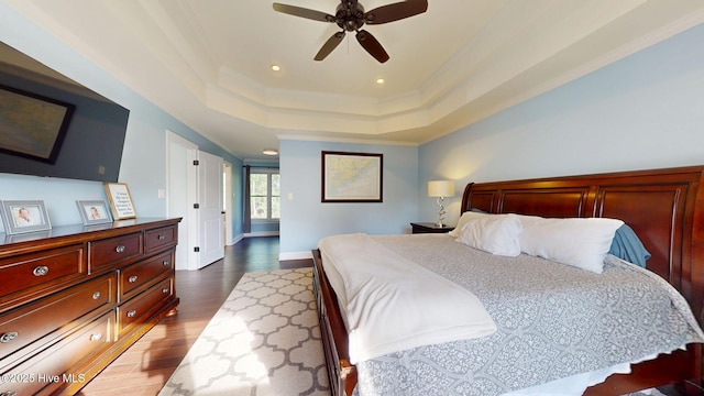 2417 Turtle Bay Dr, New Bern, NC 28562 - bedroom featuring a raised ceiling, baseboards, dark wood-style floors, ornamental molding, and recessed lighting