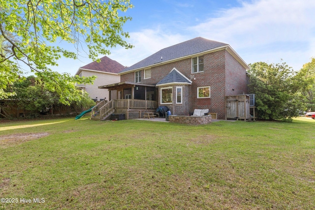 2417 Turtle Bay Dr, New Bern, NC 28562 - back of house featuring a lawn, a wooden deck, brick siding, and a patio