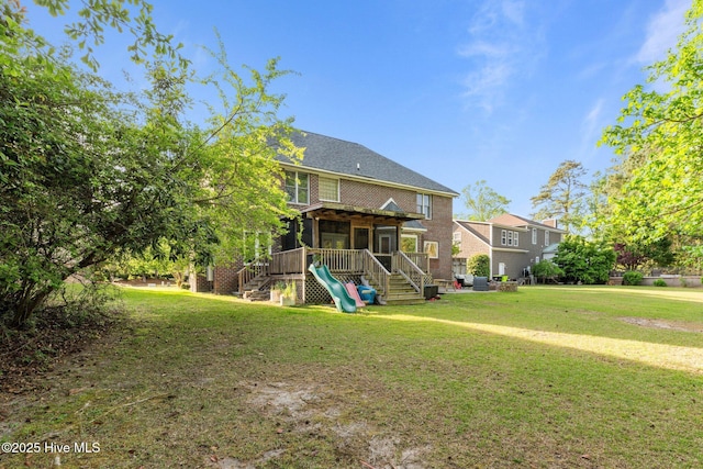 2417 Turtle Bay Dr, New Bern, NC 28562 - back of property with a sunroom, brick siding, a lawn, and stairway