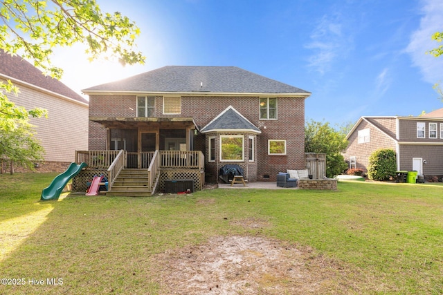 2417 Turtle Bay Dr, New Bern, NC 28562 - rear view of property featuring a yard, brick siding, a wooden deck, and a playground