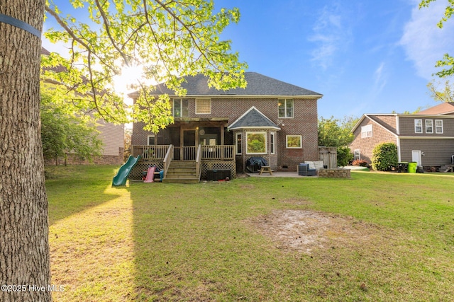 2417 Turtle Bay Dr, New Bern, NC 28562 - rear view of property with a yard, a patio, a wooden deck, and a playground