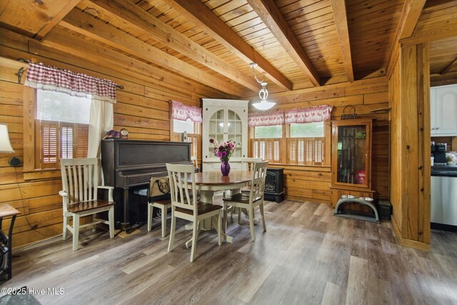 167 Puddin Ridge Rd, Moyock, NC 27958 - dining room featuring plenty of natural light, wood walls, wooden ceiling, wood finished floors, and beam ceiling