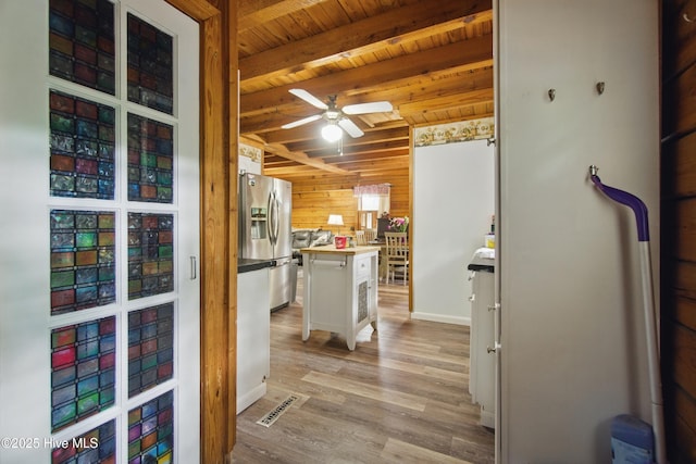 167 Puddin Ridge Rd, Moyock, NC 27958 - kitchen featuring stainless steel refrigerator with ice dispenser, wooden walls, a ceiling fan, wood ceiling, and light wood finished floors