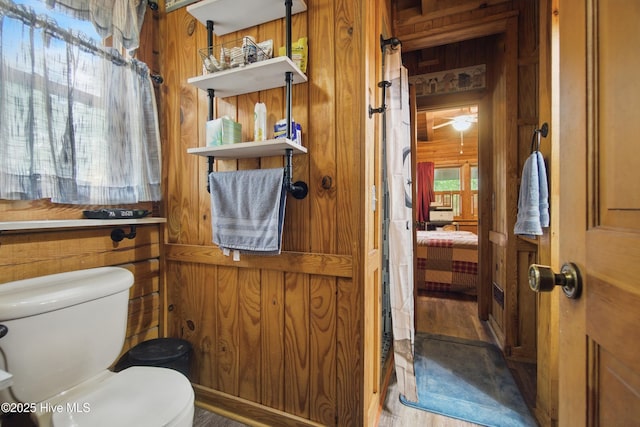 167 Puddin Ridge Rd, Moyock, NC 27958 - ensuite bathroom featuring wood walls, wood finished floors, and toilet