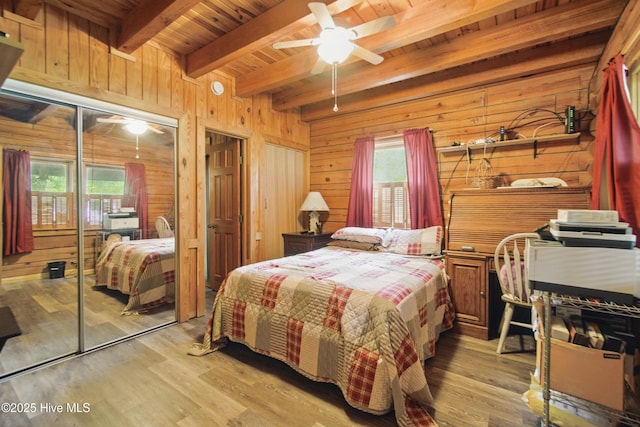 167 Puddin Ridge Rd, Moyock, NC 27958 - bedroom featuring beam ceiling, wooden walls, wood ceiling, light wood-style flooring, and a ceiling fan