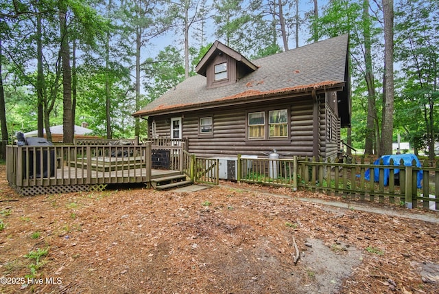 167 Puddin Ridge Rd, Moyock, NC 27958 - back of property with log exterior, a wooden deck, and roof with shingles