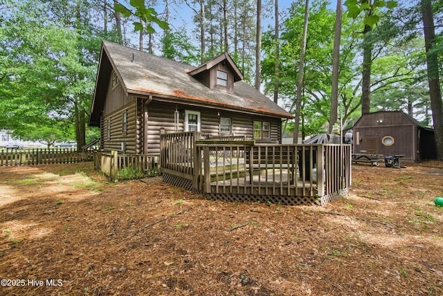 167 Puddin Ridge Rd, Moyock, NC 27958 - back of house with a storage shed, a wooden deck, fence, an outbuilding, and log exterior