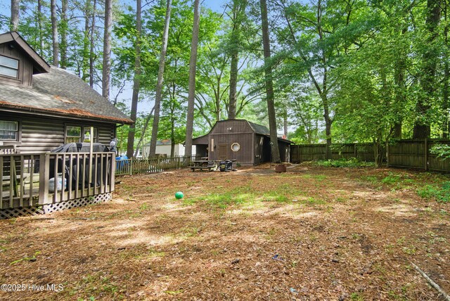 167 Puddin Ridge Rd, Moyock, NC 27958 - fenced backyard featuring an outbuilding, a deck, and a storage unit