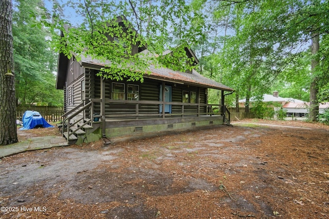167 Puddin Ridge Rd, Moyock, NC 27958 - view of front of property featuring log exterior, crawl space, covered porch, and fence