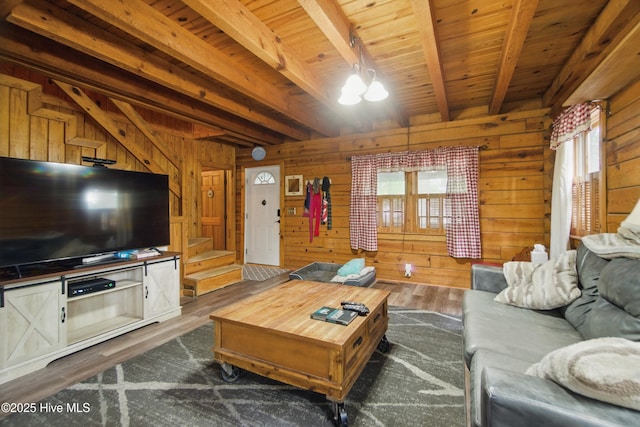 167 Puddin Ridge Rd, Moyock, NC 27958 - living area featuring beam ceiling, wooden walls, dark wood-style flooring, wood ceiling, and a chandelier
