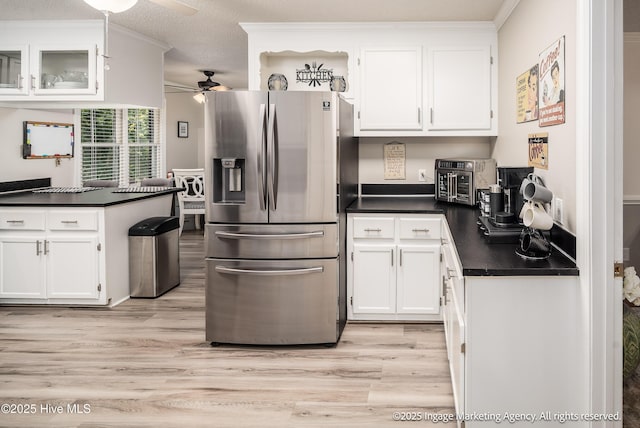 869 Driftwood Dr, Greenville, NC 27858 - kitchen featuring stainless steel fridge with ice dispenser, dark countertops, ceiling fan, white cabinetry, and crown molding