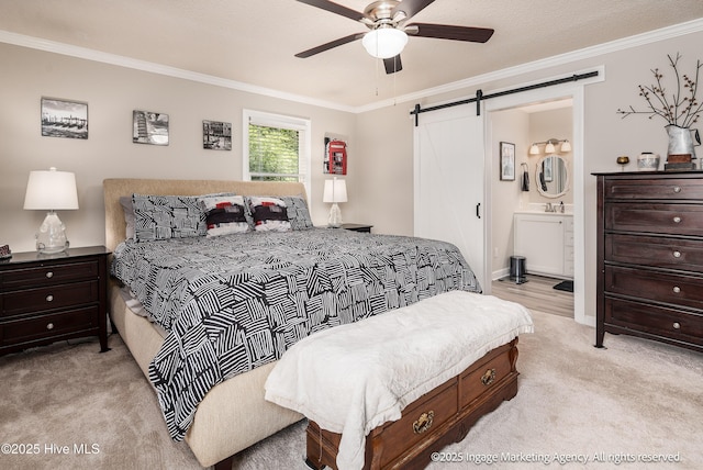 869 Driftwood Dr, Greenville, NC 27858 - bedroom with a barn door, light carpet, ornamental molding, ensuite bath, and ceiling fan