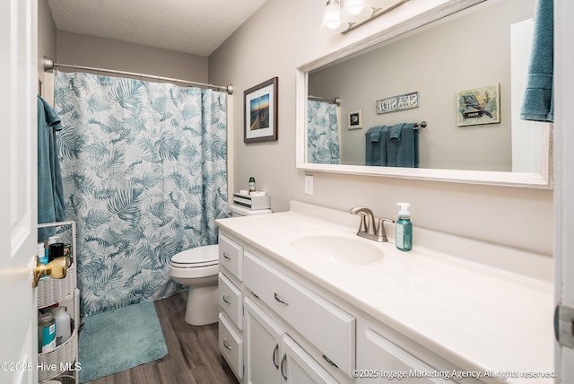 869 Driftwood Dr, Greenville, NC 27858 - full bathroom with wood finished floors, vanity, toilet, a textured ceiling, and a shower with curtain