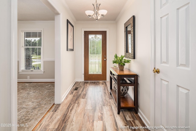 869 Driftwood Dr, Greenville, NC 27858 - entryway featuring a chandelier, wood finished floors, crown molding, and baseboards