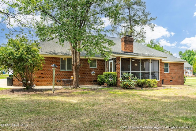 869 Driftwood Dr, Greenville, NC 27858 - rear view of property featuring a yard, brick siding, a chimney, roof with shingles, and a sunroom