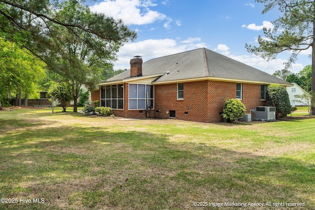 869 Driftwood Dr, Greenville, NC 27858 - back of house with a sunroom, a lawn, a chimney, and central AC