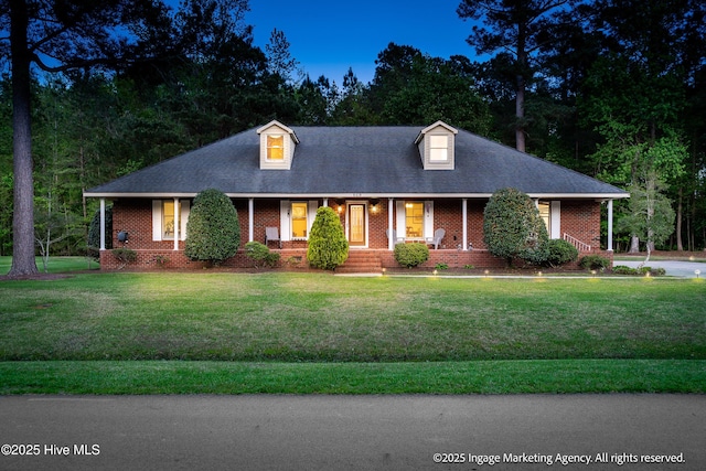 869 Driftwood Dr, Greenville, NC 27858 - view of front of property featuring brick siding, a porch, and a front lawn