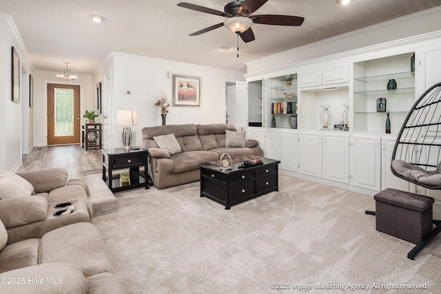 869 Driftwood Dr, Greenville, NC 27858 - living area featuring crown molding, a ceiling fan, a chandelier, and light carpet