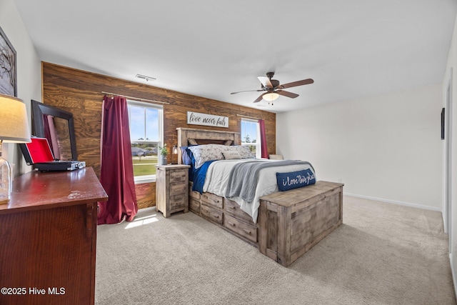 bedroom with wood walls, visible vents, and carpet floors