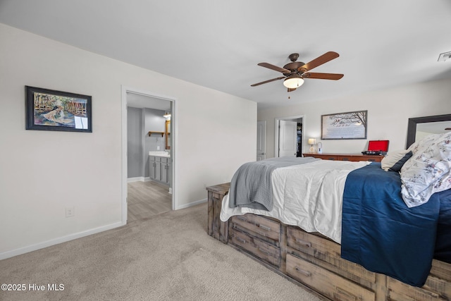 carpeted bedroom with connected bathroom, visible vents, baseboards, and a ceiling fan