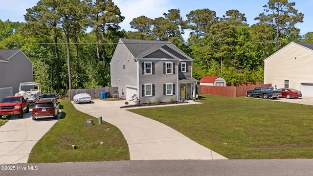 colonial house with fence, a front yard, and driveway