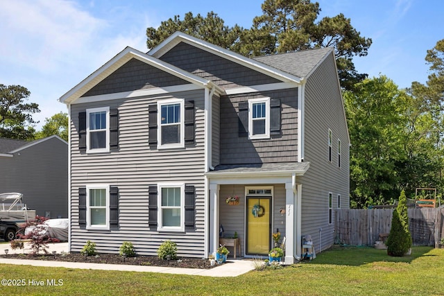 view of front of home with fence and a front yard