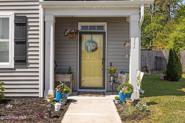 view of exterior entry with fence