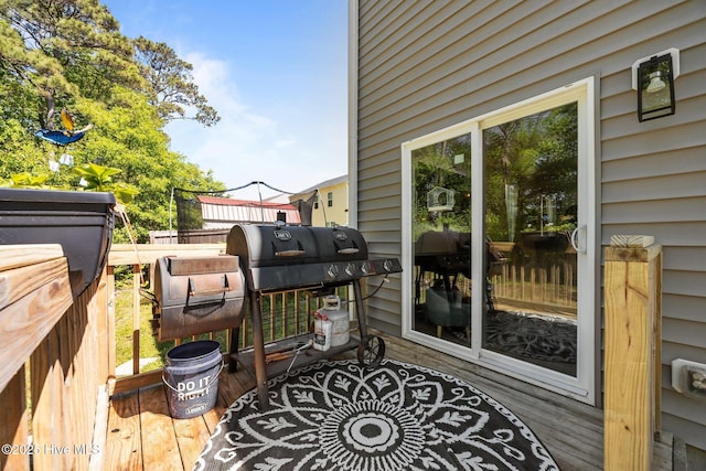 wooden terrace featuring fence and area for grilling