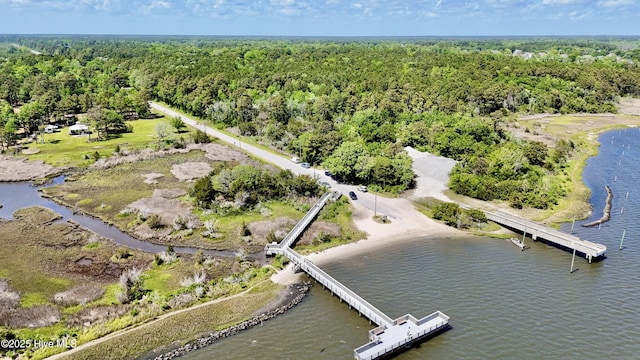drone / aerial view featuring a water view and a forest view