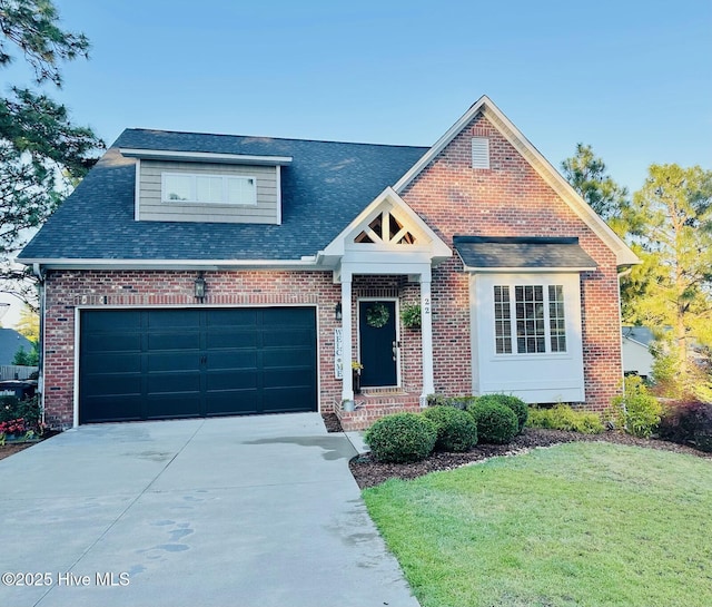 22 Calhoun Ln, Pinehurst, NC 28374 - view of front of house with driveway, a front yard, an attached garage, and brick siding
