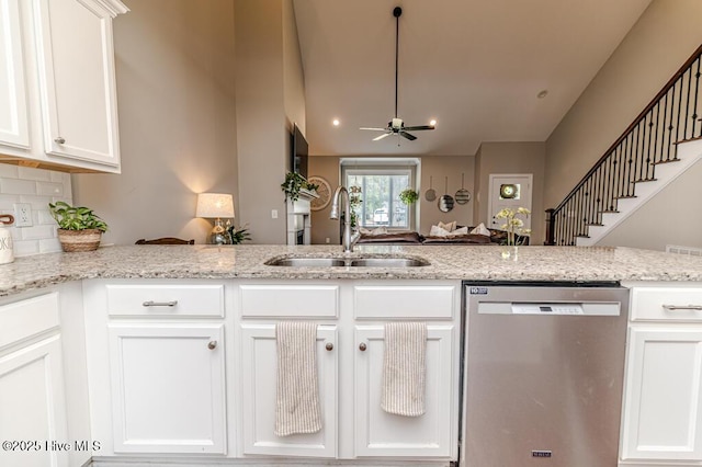 22 Calhoun Ln, Pinehurst, NC 28374 - kitchen with dishwasher, a sink, a ceiling fan, white cabinets, and decorative backsplash